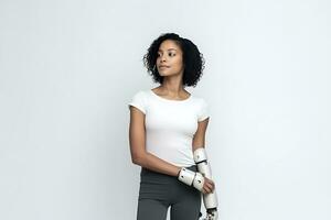 A disabled African American woman in a white T-shirt with prostheses instead of hands posing on a white background. AI Generative photo