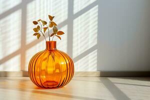 AI Generative. Large orange glass pumpkin against a white wall. The wall is illuminated by bright sunlight. Silhouette of a window frame on a white wall. Horizontal photo