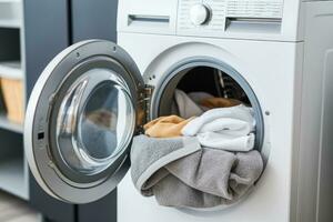 Person puts things into the washing machine photo