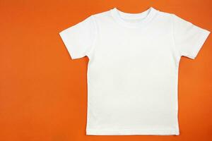 White womens cotton tshirt mockup on orange background. Design t shirt template, print presentation mock up. Top view flat lay. photo