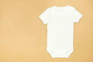 White baby girl or boy bodysuit mockup flat lay on craft paper background. Design onesie template, print presentation mock up. Top view. photo