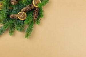 Christmas flat lay background with fir tree branches, pine cones and christmas decorations on craft paper background. Top view. Copy space. photo