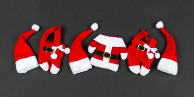Top view Banner of red Santa hats and clothes on colorful background. Merry Christmas concept with copy space photo
