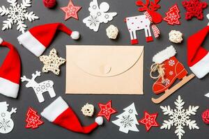 Top view of craft envelope. New Year decorations on black background. Merry Christmas concept photo