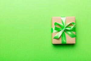 Holiday present box over colored background, top view. Copy space for design photo