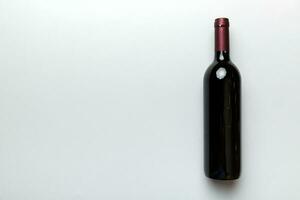 One Bottle of red wine on colored table. Flat lay, top view wth copy space photo