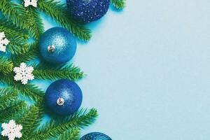 Christmas composition made of fir tree, balls and different decorations on colorful background. Top view of New Year Advent concept with empty space for your design photo