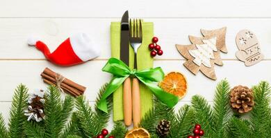 Top view of Banner utensils on festive napkin on wooden background. Christmas decorations with dried fruits and cinnamon. New year dinner concept with copy space photo