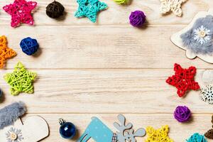 Top view of Christmas decorations and toys on wooden background. Copy space. Empty place for your design. New Year concept photo