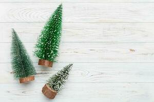 Flat lay composition with christmas trees on color background. Top view with copy space photo