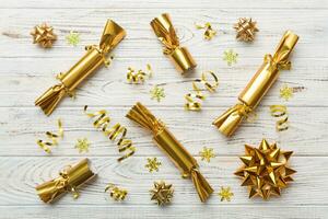 Christmas crackers with shiny confetti on color background, top view, copy space photo