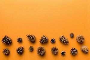 Christmas pine cones on colored paper border composition. Christmas, New Year, winter concept. Flat lay, top view, copy space photo