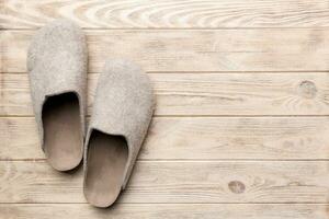 Warm winter women woolen slippers on the floor. Copy space for text photo