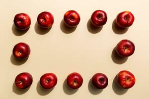 Many red apples on colored background, top view. Autumn pattern with fresh apple above view photo