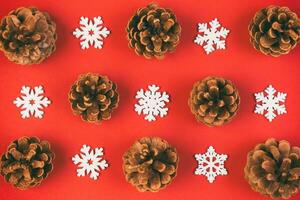 Top view of holiday composition made of pine cones and white snowflakes on colorful background. Winter time and Christmas concept with copy space photo