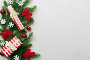 Christmas decorations and fir tree branch and gift boxon dark table. Top view frame with copy space photo