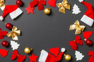 Top view of black background with New Year toys and decorations. Christmas time concept with copy space photo