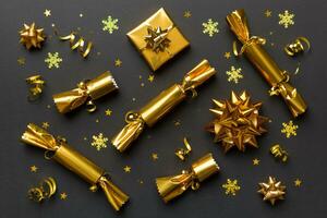 Christmas crackers with shiny confetti on color background, top view, copy space photo