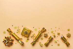 Christmas crackers with shiny confetti on color background, top view, copy space photo