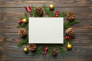 Flat lay Christmas composition. square Paper blank, pine tree branches, christmas decorations on Colored background. Top view, copy space for text photo