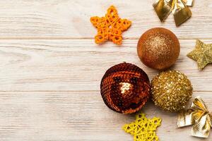 Creative set of New Year baubles and decorations on wooden background. Top view of Christmas time concept. Copy space photo