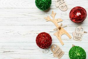 New Year composition made of baubles, reindeer and other decorations on wooden background. Christmas time concept with empty space for your design photo