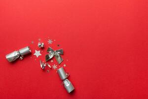 Christmas crackers with shiny confetti on color background, top view, copy space photo