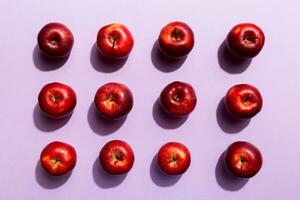 Many red apples on colored background, top view. Autumn pattern with fresh apple above view photo