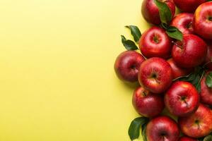 Many red apples on colored background, top view. Autumn pattern with fresh apple above view with copy space for design or text photo