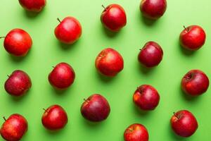 Many red apples on colored background, top view. Autumn pattern with fresh apple above view photo