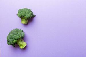 Top view fresh green broccoli vegetable on Colored background. Broccoli cabbage head Healthy or vegetarian food concept. Flat lay. Copy space photo