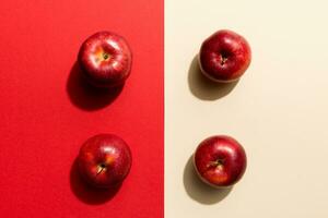 Many red apples on colored background, top view. Autumn pattern with fresh apple above view photo