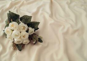 Fresh white flowers on smooth elegant silk. Nature aesthetic. Minimal concept and simplicity. Luxury layout. photo
