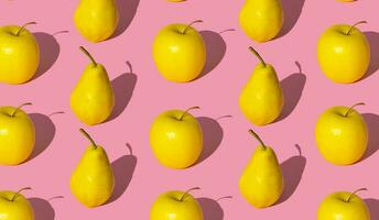 Trendy fruit pattern made of yellow pears and apples on light pastel pink background. Minimal layout. Nature summer concept. photo