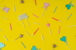 Trendy pattern made of birthday party things on light yellow background. Creative birthday concept. Minimal birthday party idea. Trendy flat lay pattern composition. Top of view. photo