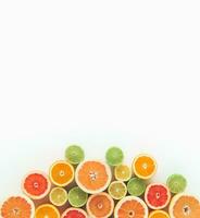 Creative summer concept made of various citrus fruits on white background. Minimal layout. Flat lay, top of view. photo