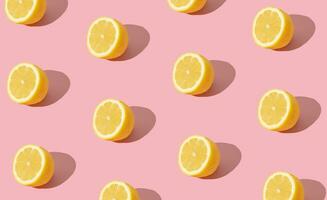 Trendy sunlight summer fruit pattern made with yellow lemon slice on bright light pink background. Minimal summer concept. Creative food idea. lemons aesthetic. photo