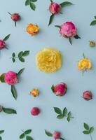 Creative pattern made of colorful flowers on pastel blue background. Minimal flat lay style. Flowers aesthetic. photo