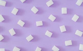 Creative pattern made of sugar cubes on pastel violet background. Minimal food concept. Trendy flat lay pattern background composition. Fancy sugar cubes idea. Top of view. photo