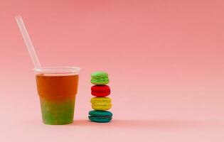 Creative layout made of colorful tasty macarons and fresh bubble tea on pink background. Minimal food and drink concept. Trendy macaron cookies and bubble tea idea. Yummy sweet food composition. photo