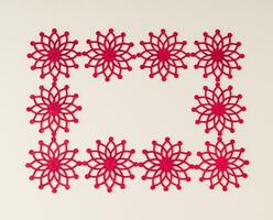 Luxurious frame made of red Christmas objects on pastel background. Minimal border composition. Creative Christmas or New Year concept. Trendy holiday idea. Flat lay, top of view. photo