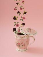 Creative layout made of various flowers flying out of a cup of tea against bright light pink background. Minimal autumn tea concept. Trendy flowers and tea idea. photo