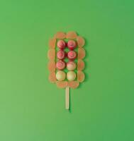 Ice cream made with gummy candies on pastel green background. Minimal summer concept. photo