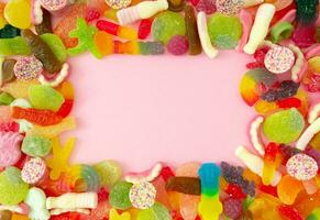 Creative background made of gummy candies with copy space. Colorful flat lay. Jelly sweets aesthetic. photo