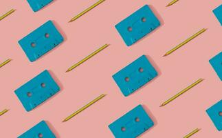 You're the pencil to my cassette tape. Retro cassette tapes and pencils pattern on light pastel pink background. Creative music old cassettes pattern. Retro fashion aesthetic background. photo