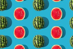 You are one in a melon. Trendy summer fruit pattern made of watermelon on light blue background. Natural food background concept. Minimal watermelon pattern idea. Summer fruit aesthetic. Flat lay. photo