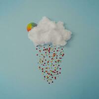 Creative cloud with colorful sprinkles and gummy candy. Minimal concept background. photo