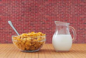 Creative layout made of corn flakes in glass bowl and milk against red brick wall background. Minimal food and drink concept. Trendy breakfast cereal idea. Breakfast food aesthetic. photo