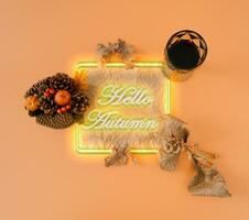 Creative autumn or fall  fluorescent color layout with leaves, little pumpkins and glass of red wine on pastel orange background. Minimal nature seasonal concept. Flat lay neon colors composition. photo