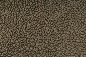 Trendy brown fur backdrop. Minimal background and texture concept. Flat lay cosy fur background idea. Copy space. photo